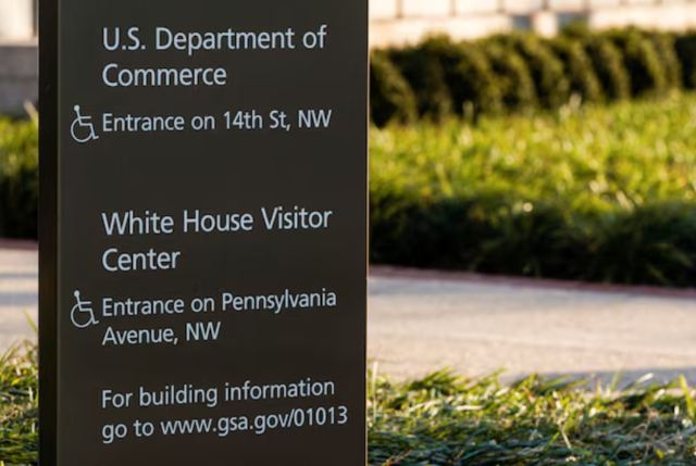 A sign in front of Department of Commerce building is seen before an expected report of new home sales numbers in Washington, US, January 26, 2022.